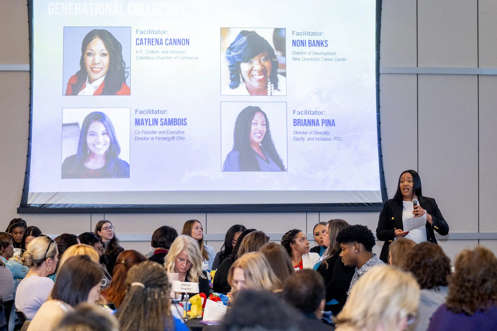 Speaker presenting to Women in Thought Summit attendees with the Generational Collective session slide visible behind her.
